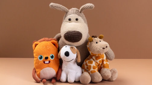 Custom character plush toys displayed on a shelf showing brand IP soft toy merchandise