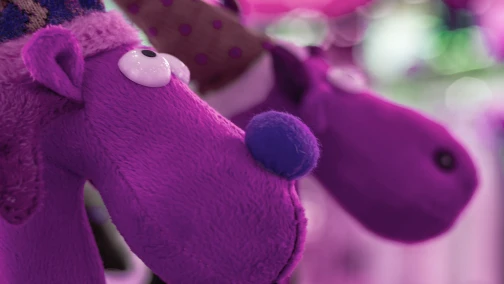 Assorted claw machine plush toys in seven-to-ten-inch standard sizes inside a prize crane cabinet