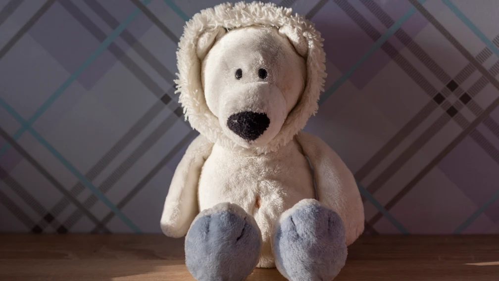 Custom weighted plush toys with glass microbead filling on factory production table