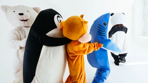 Custom mascot costume with an oversized foam head and fur body worn by a performer at an outdoor brand event