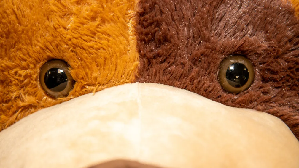 Factory engineers adjusting the internal PVC armature of a giant custom plush bear before final stuffing