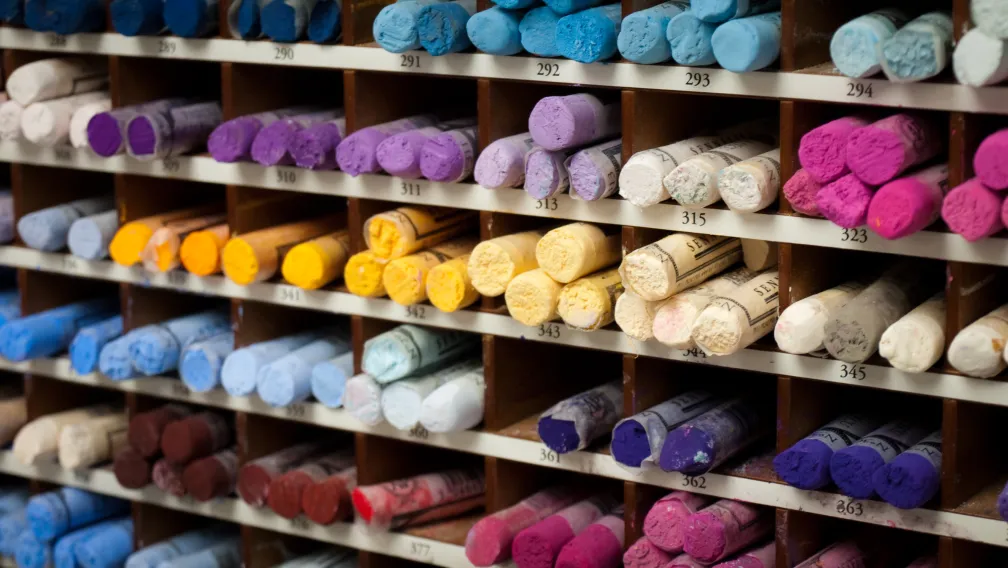 Rolls of colored plush fabrics and textile samples in a manufacturing material warehouse